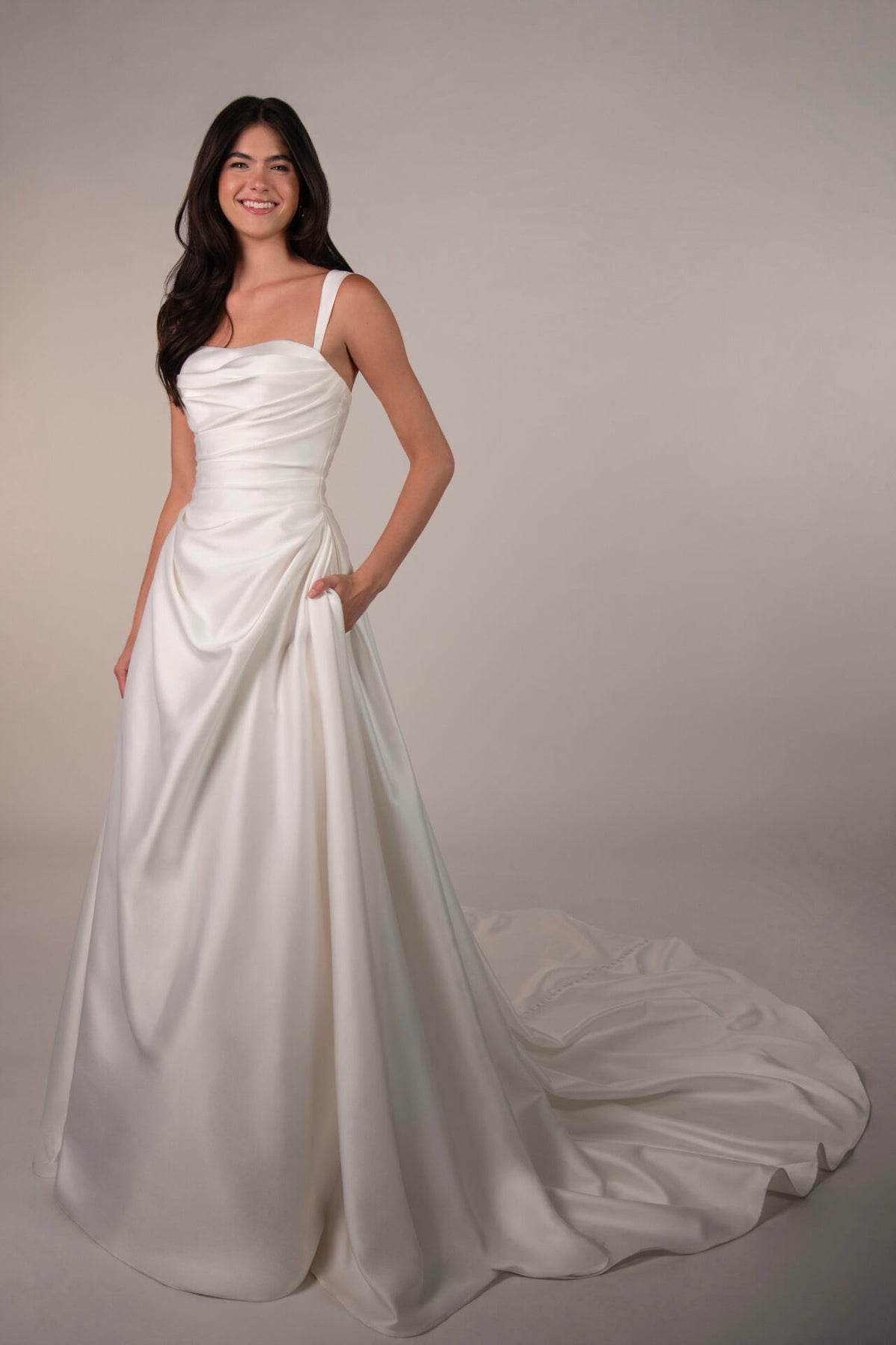 Elegant Stella York Marion wedding gown with intricate lace details and flowing train, shown on a model.