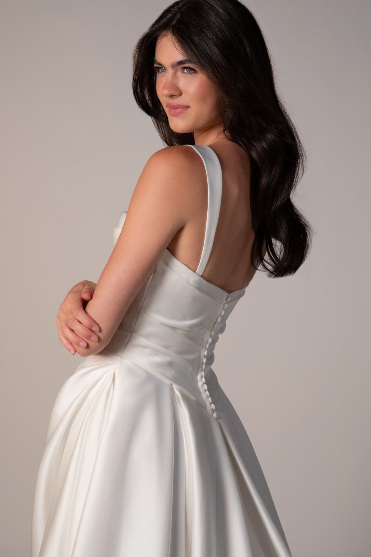 Stella York Marion wedding gown with lace details and flowing train, shown on a model in a bridal setting.