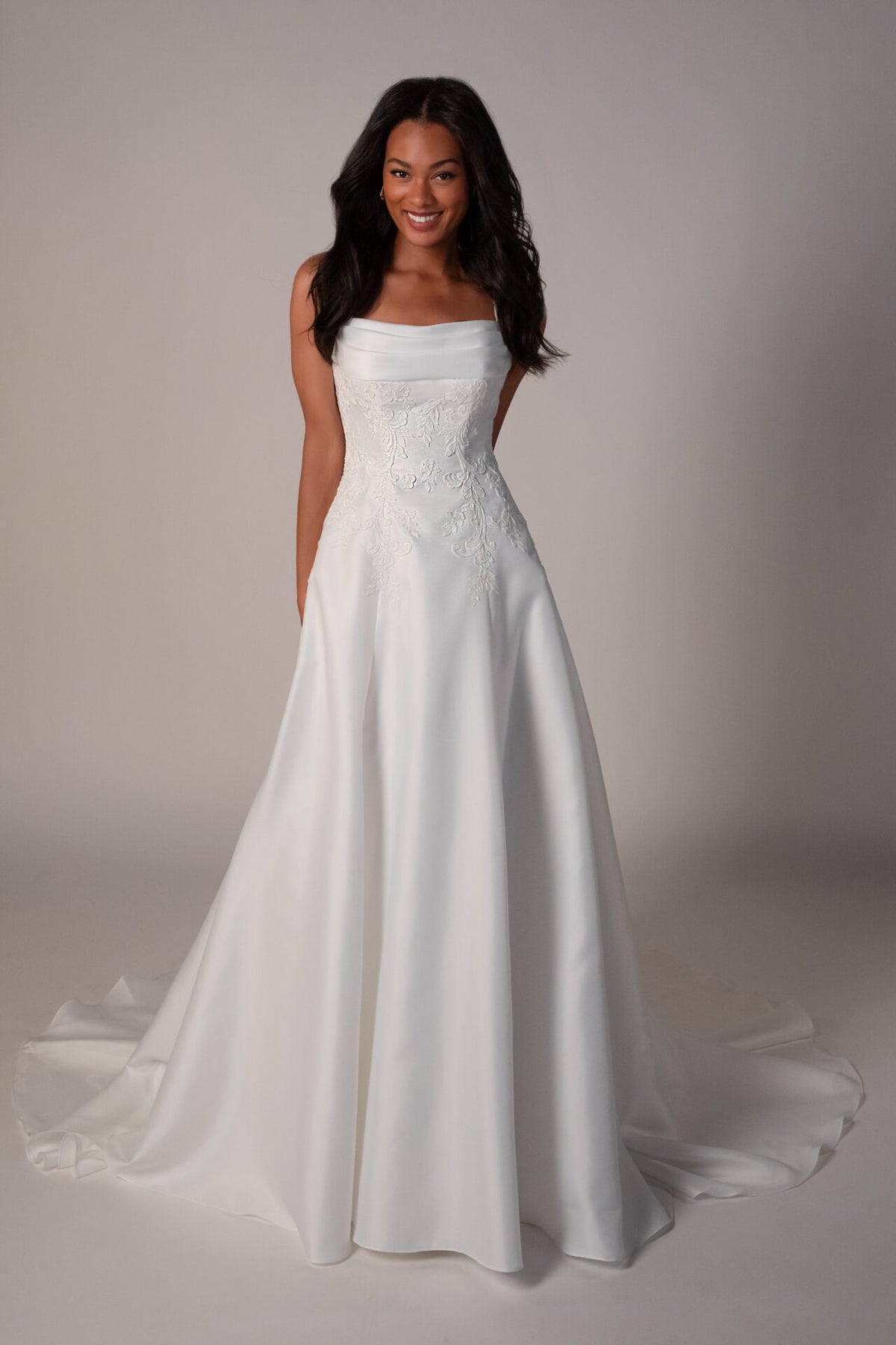 Stella York Margate wedding gown arriving December, elegant lace dress with flowing train, displayed on a mannequin.