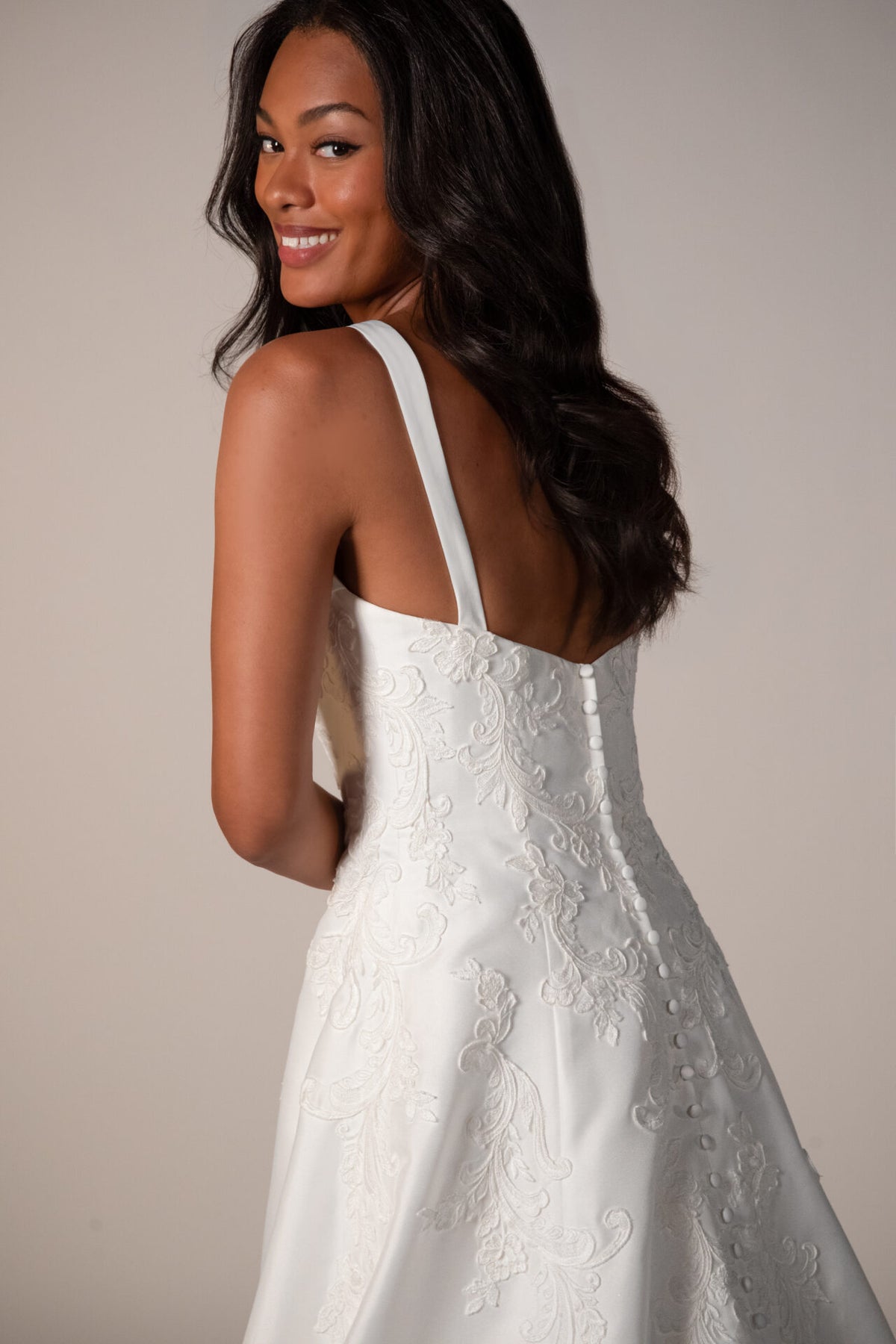 Stella York Margate wedding gown with lace details and flowing train, arriving December, shown in elegant white fabric.