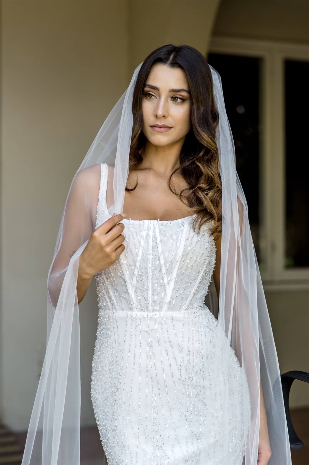 Ivory Glimmer Tulle Raw Edge Veil by Dreamtime, 45-inch accessory with shimmering tulle and raw edge detail for wedding attire.